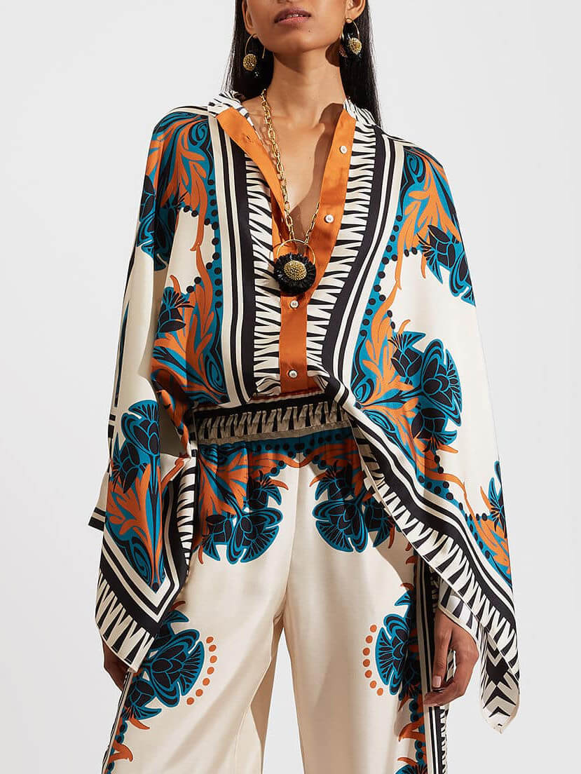 BUCINE - Completo arancio satinato con stampa floreale e maniche batwing